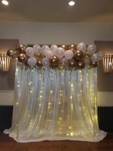 Gold and pink balloon lighted backdrop