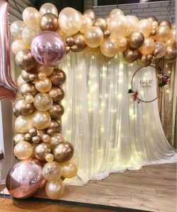Gold balloons and lighted backdrop