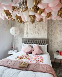 Bedroom decorated with chocolates and balloons