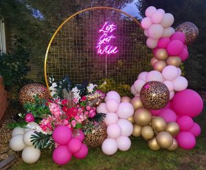 neon birthday backdrop, sign and balloons